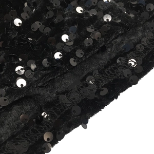 Detail shot of black sequin fabric on velvet mesh with high-quality seam craftsmanship