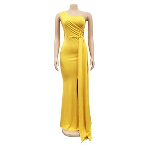 Detail of a bright yellow one-shoulder bodycon maxi dress with ruched fabric and high slit