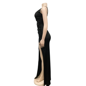 Detail view of black satin evening gown featuring waist pleats and a side high slit