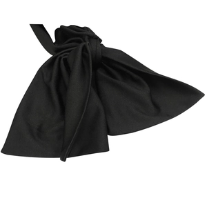 Detailed close-up of a black textured bow ornament for an elegant one-shoulder dress