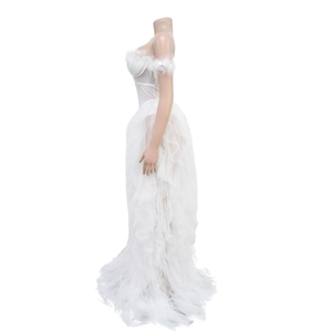 Detail view of the elegant white feather trim on the strapless bodice of the long mesh gown