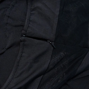 Close-up of invisible zipper and black mesh stitching on a feather strapless mini dress