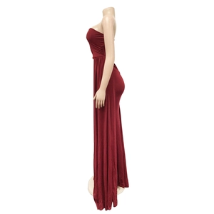 Detail of elegant high-waisted red tube maxi dress with flowing draped skirt