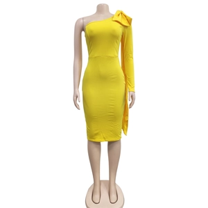 Detail of the large shoulder bow and asymmetric draped design on the yellow dress
