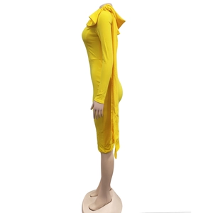 Detail of the bright yellow dress showing the long flowing sash at the back of the neckline