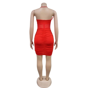 Detail of red tube mini dress featuring ruching, feather trim and rhinestone strap