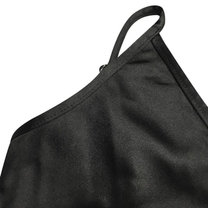 Close-up of sleek black dress showing fine shoulder strap and neat edge stitching