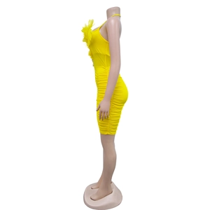 Detail view of yellow ruched bodycon dress featuring feather trim and thin straps