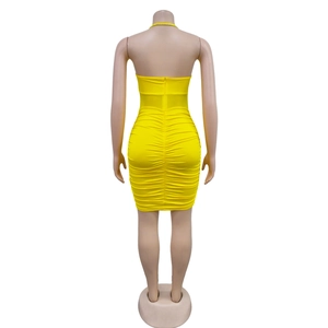 Detailed back view of a yellow ruched mini dress with a zipper and crystal trim