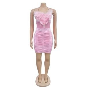 Detail of pink ruched mini dress with feather trim and sparkling diamond brooch