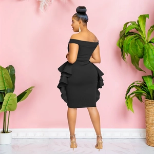 Detail of the layered ruffle pleats and slim fit silhouette of the black off-shoulder dress