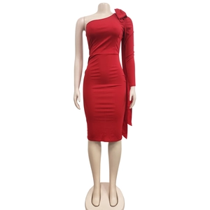 Detail view of red one-shoulder fitted dress with large bow on the long sleeve