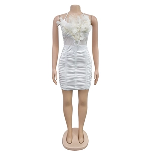 Detail of white bodycon mini dress featuring feather trim and sparkling rhinestone accents