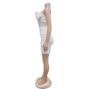 Detail of white tube mini dress with feather trim, mesh paneling and ruched fabric