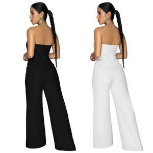 Detail view of strapless jumpsuit showing back zipper and wide leg cut in black and white