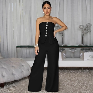 Sleeveless black strapless jumpsuit with silver buttons and wide-leg trousers