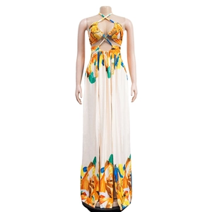 Detailed close-up of a halter neck maxi dress with vibrant abstract prints and waist cut-out