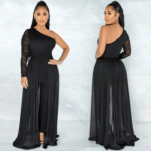 Detail view of black one-shoulder jumpsuit with sheer mesh sleeve and side overlay