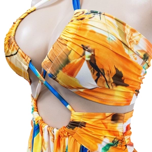 Detail view of the orange floral ruched dress with blue straps and cutout design