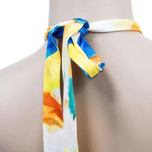 Detail of multi-color tie-dye halter neck strap with knot on sleeveless maxi dress