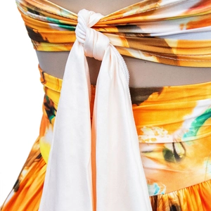 Detailed back view of a summer floral dress featuring an adjustable cream ribbon tie
