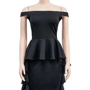 Detail view of the black off-shoulder dress featuring peplum waist and ruffled hem accents