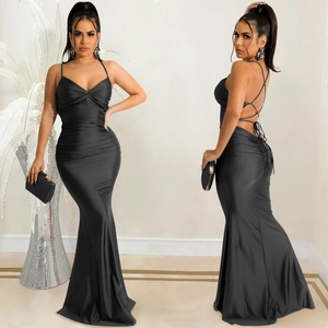 Detail view of black backless evening dress showing crisscross lace-up straps and fishtail hem