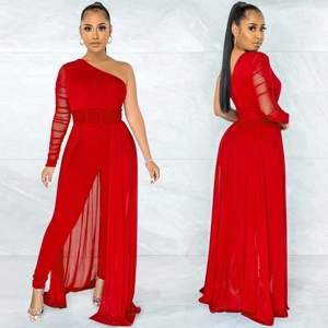 Detail of red one-shoulder jumpsuit with mesh overlay and stylish waist belt