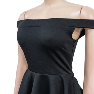 Detail shot of the black off-shoulder dress featuring a waist-cinching cut and ruffle hem