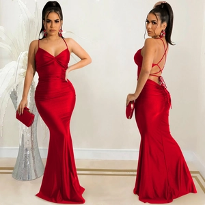 Detail of red backless satin evening dress with crisscross tie straps and slim fit design