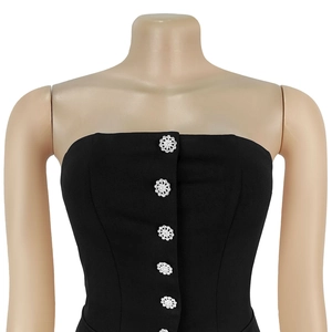 Detailed view of black strapless tube top with ornate floral rhinestone buttons and corset fit