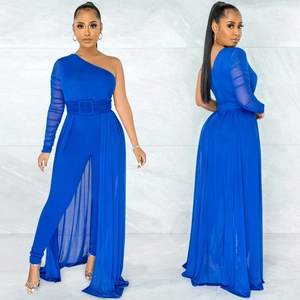 Detail of royal blue one-shoulder jumpsuit with sheer mesh overlay and belted waist