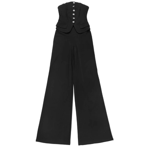 Detail of black strapless jumpsuit featuring wide legs and decorative silver buttons