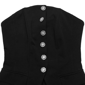 Detail of elegant black strapless jumpsuit featuring sparkling crystal flower buttons