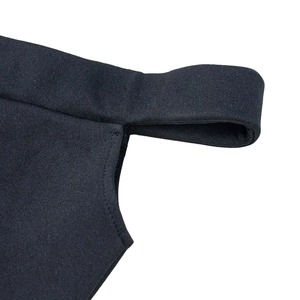 Detailed macro view of black off-shoulder dress stitching and high-quality knit fabric