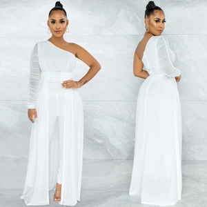 Detail of white one-shoulder mesh jumpsuit with ruffled sleeves and matching belt