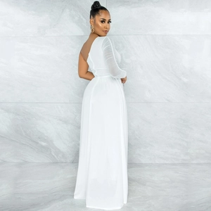 Detail of white one-shoulder jumpsuit featuring sheer mesh sleeve and elegant floor-length cut