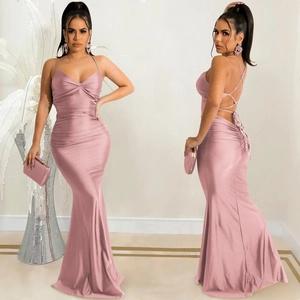 Detail showing the lace-up open back and elegant mermaid cut of this pink satin maxi dress