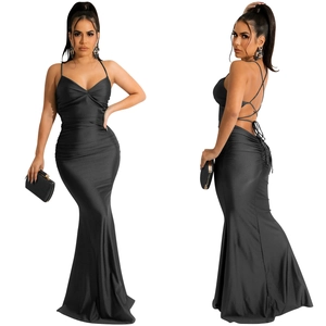 Detail view showing backless cross bandage design and mermaid hem of the black satin maxi dress