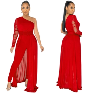 Detail of red one-shoulder jumpsuit with sheer mesh sleeves and layered chiffon skirt
