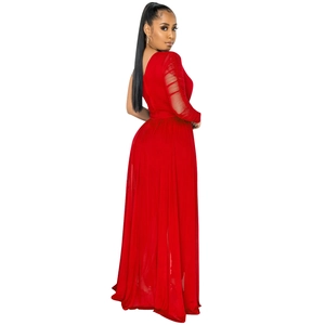 Detail of red sheer mesh ruffled sleeve and asymmetric neckline on the jumpsuit