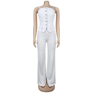 Detail of white tube top vest with shiny buttons and matching wide-leg trousers
