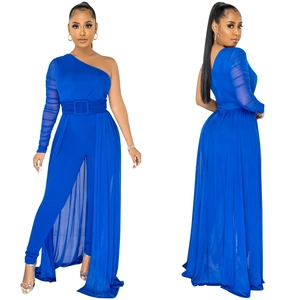 Detail view of royal blue one-shoulder mesh jumpsuit with belt and sheer skirt overlay