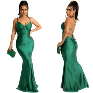 Detail of emerald green satin mermaid dress showing backless lace-up and elegant ruched texture