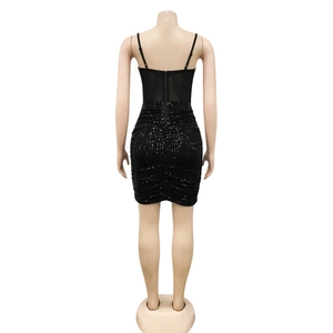Detail view of black sequin mini dress back with mesh patchwork and invisible zipper