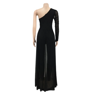 Detail view of black one shoulder jumpsuit with sheer mesh long sleeve and flowing overlay