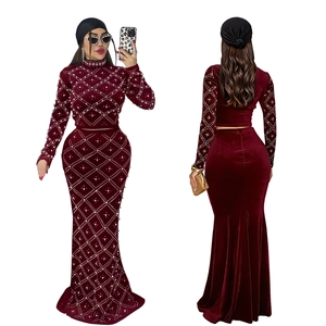 Detail of burgundy velvet top and fishtail skirt with diamond and pearl grid pattern