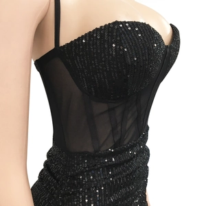 Detail of sexy black sequin corset dress featuring sheer mesh waist and boning structure