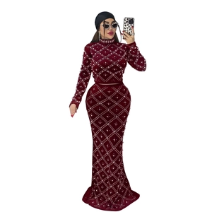 Detail of burgundy velvet top and skirt set with pearl and rhinestone diamond pattern