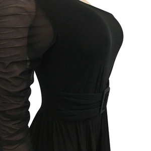 Detail of sheer mesh sleeve with ruching and belted waist on a black bodysuit